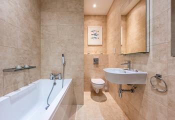 The family bathroom has a bath for relaxing evenings after coast path walks.