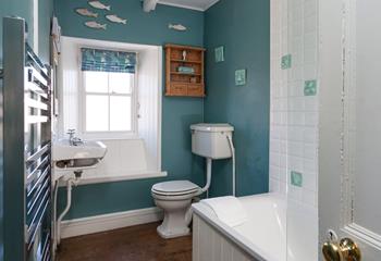 The family bathroom has a bath with shower over, WC and basin.