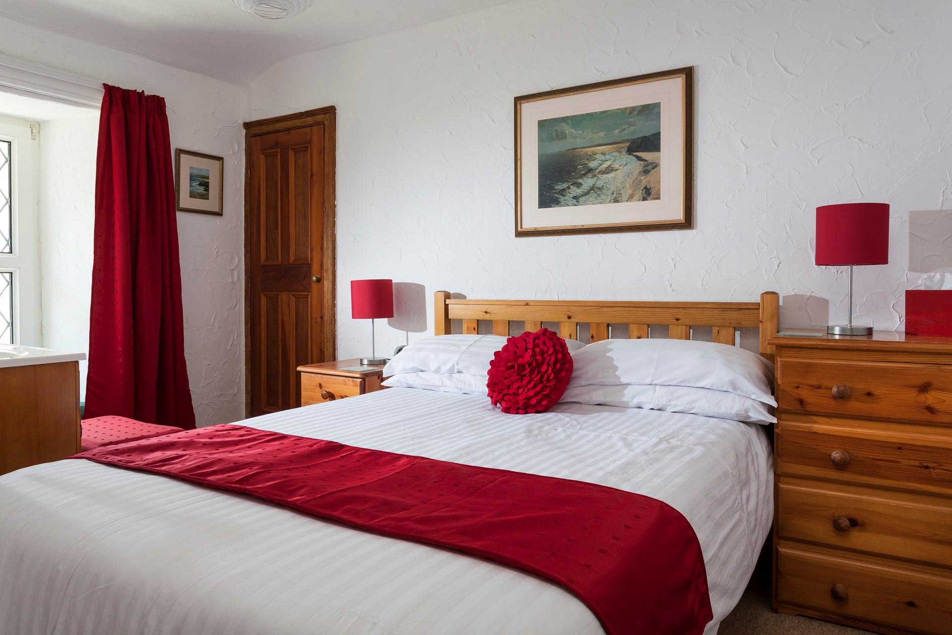 Bedroom 1 is located at the front of the cottage on the first floor.