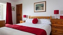 Bedroom 1 is located at the front of the cottage on the first floor.