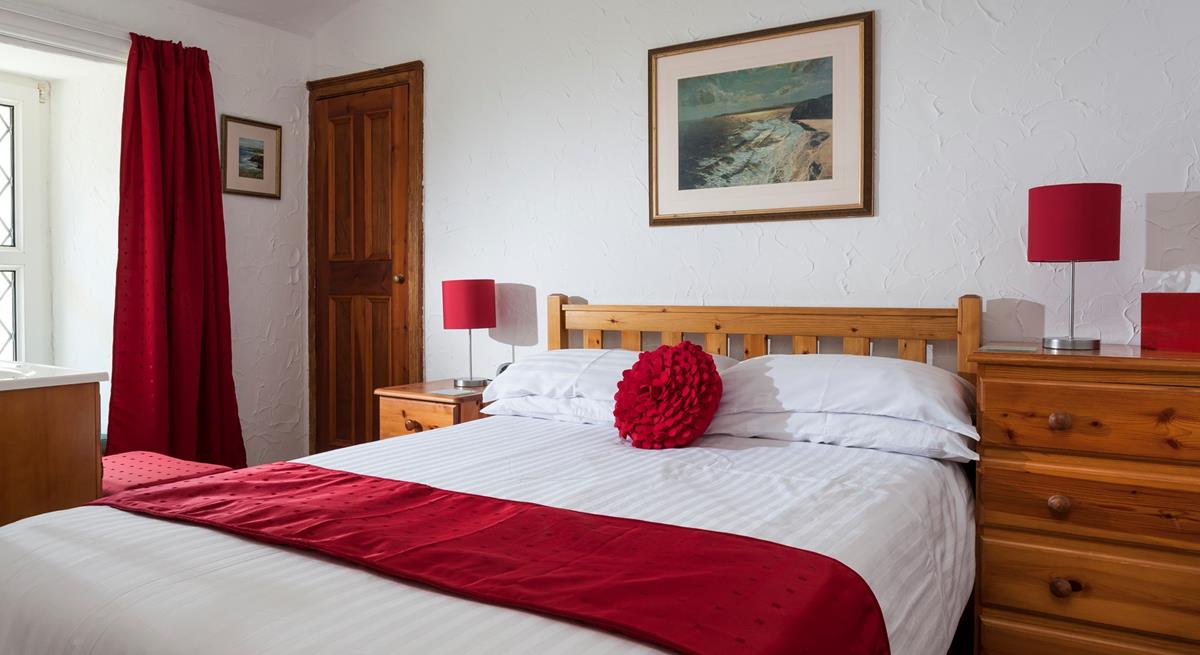 Bedroom 1 is located at the front of the cottage on the first floor.