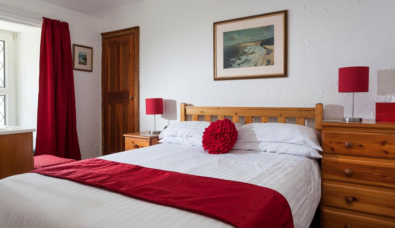 Bedroom 1 is located at the front of the cottage on the first floor.