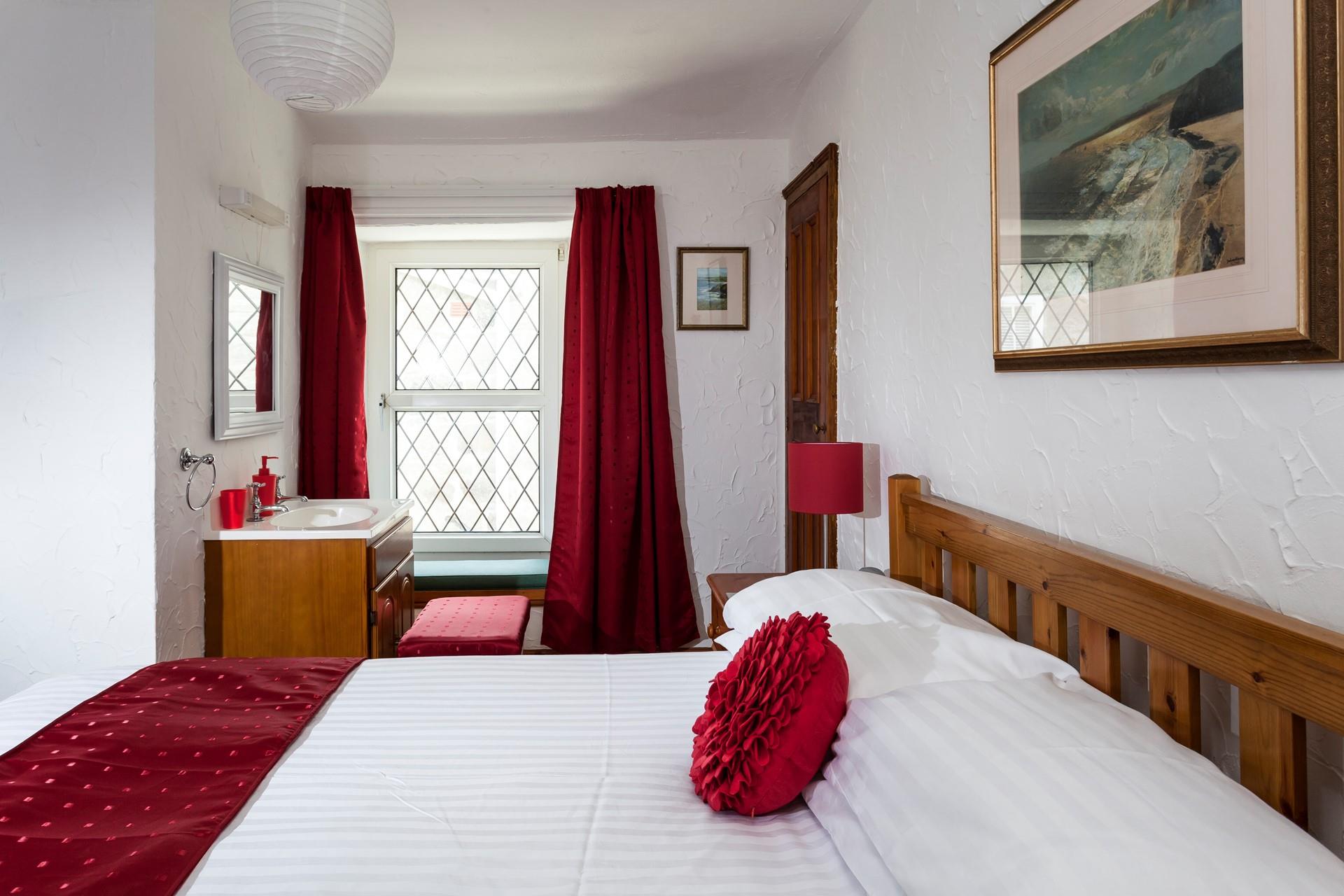 Bedroom 1 has a basin and a spacious double bed offering a peaceful night's sleep.
