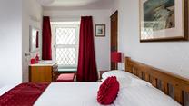 Bedroom 1 has a basin and a spacious double bed offering a peaceful night's sleep.