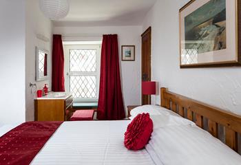 Bedroom 1 has a basin and a spacious double bed offering a peaceful night's sleep.