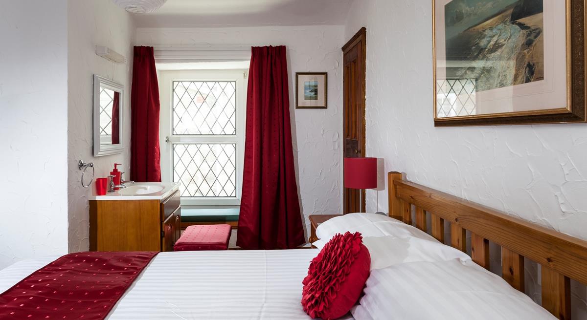 Bedroom 1 has a basin and a spacious double bed offering a peaceful night's sleep.