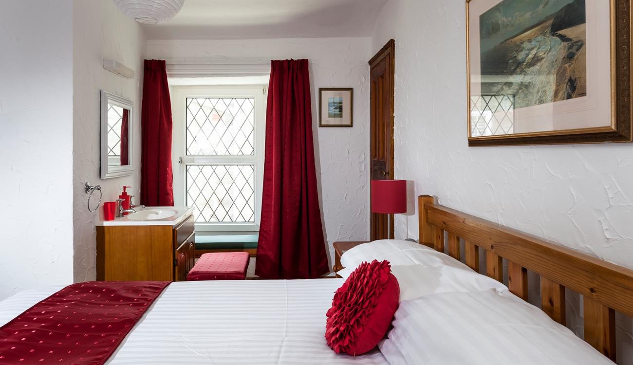 Bedroom 1 has a basin and a spacious double bed offering a peaceful night's sleep.