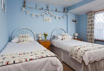 Bedroom 2 has seaside decor reflecting the cottage's close proximity to the sea.