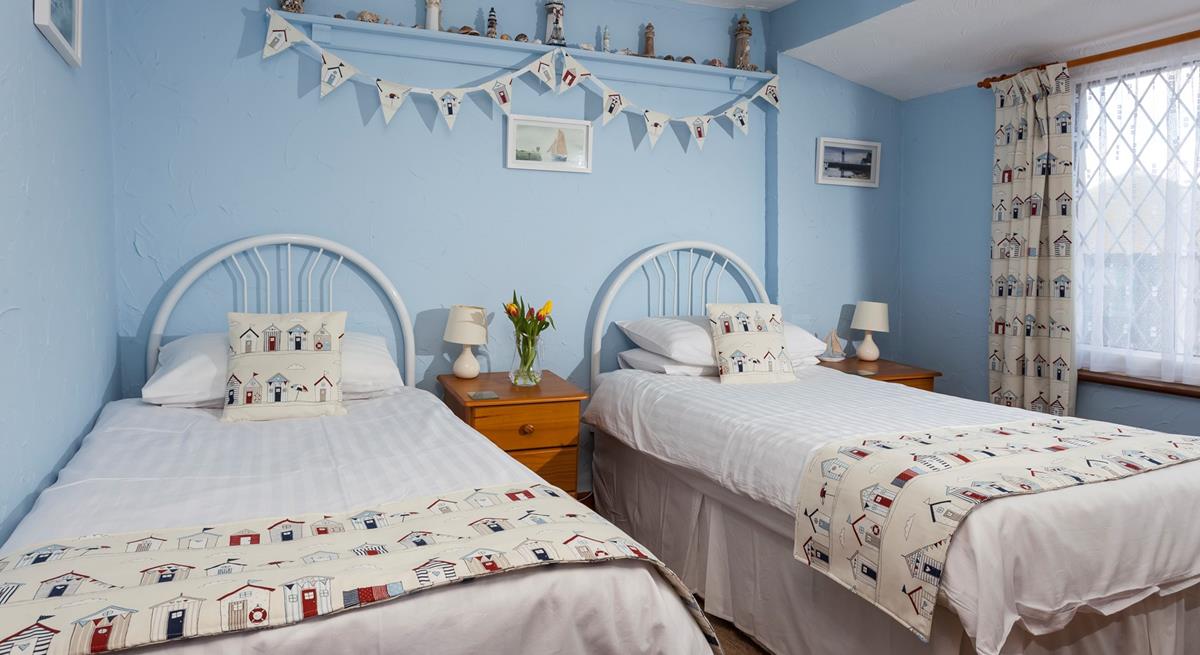 Bedroom 2 has seaside decor reflecting the cottage's close proximity to the sea.