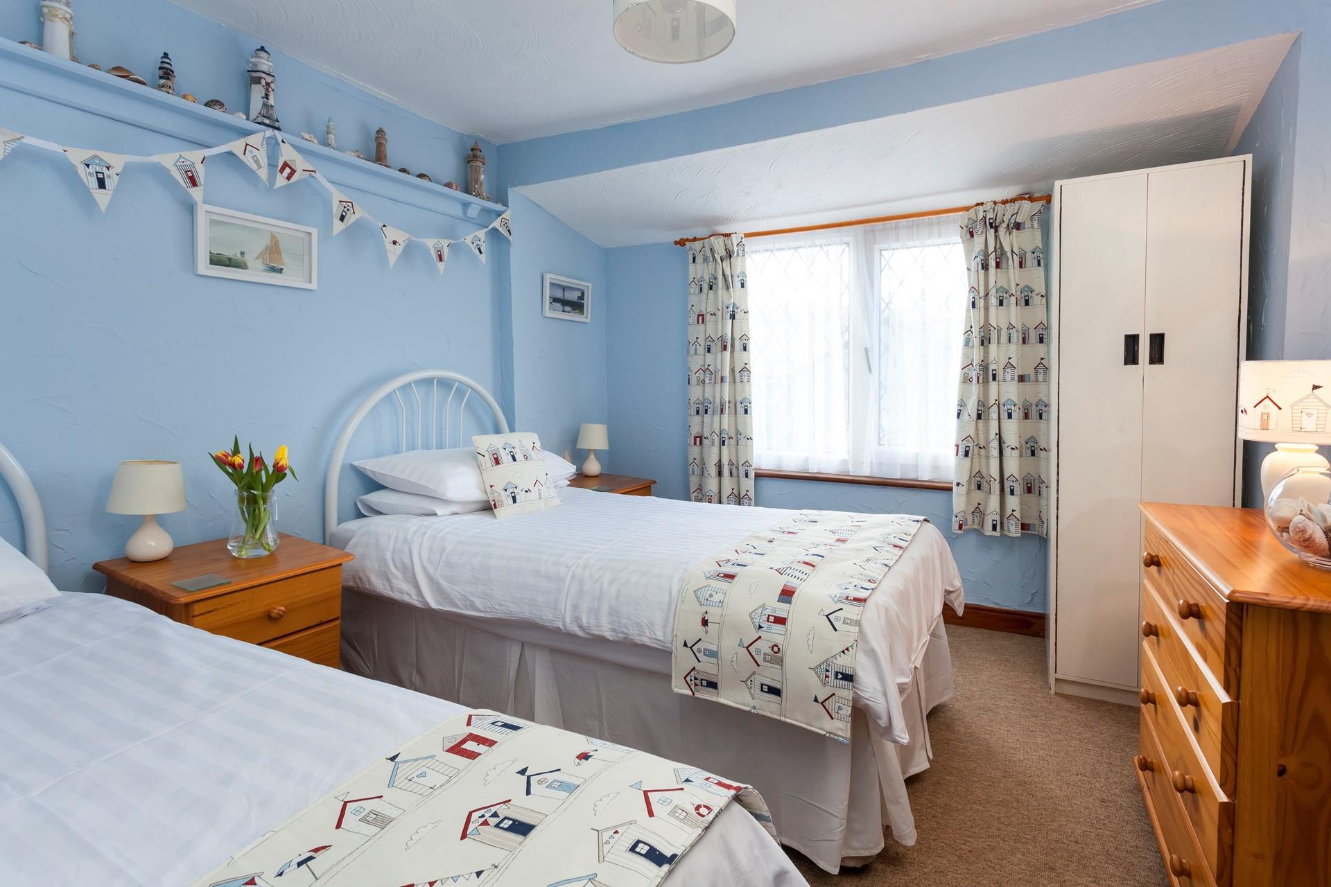 There is a handy chest of drawers and a wardrobe for all your holiday clothes.