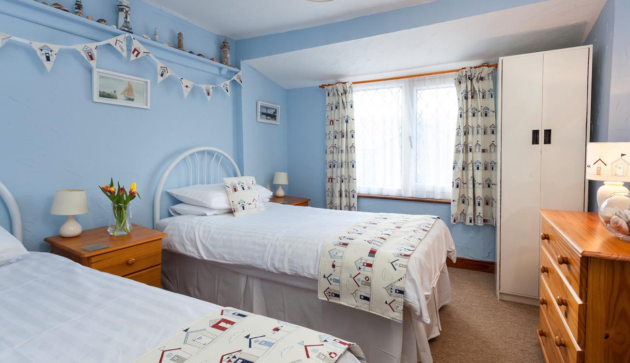 There is a handy chest of drawers and a wardrobe for all your holiday clothes.