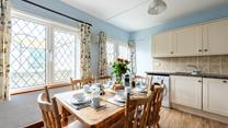 Enjoy dining around the farmhouse style table with seating for six.