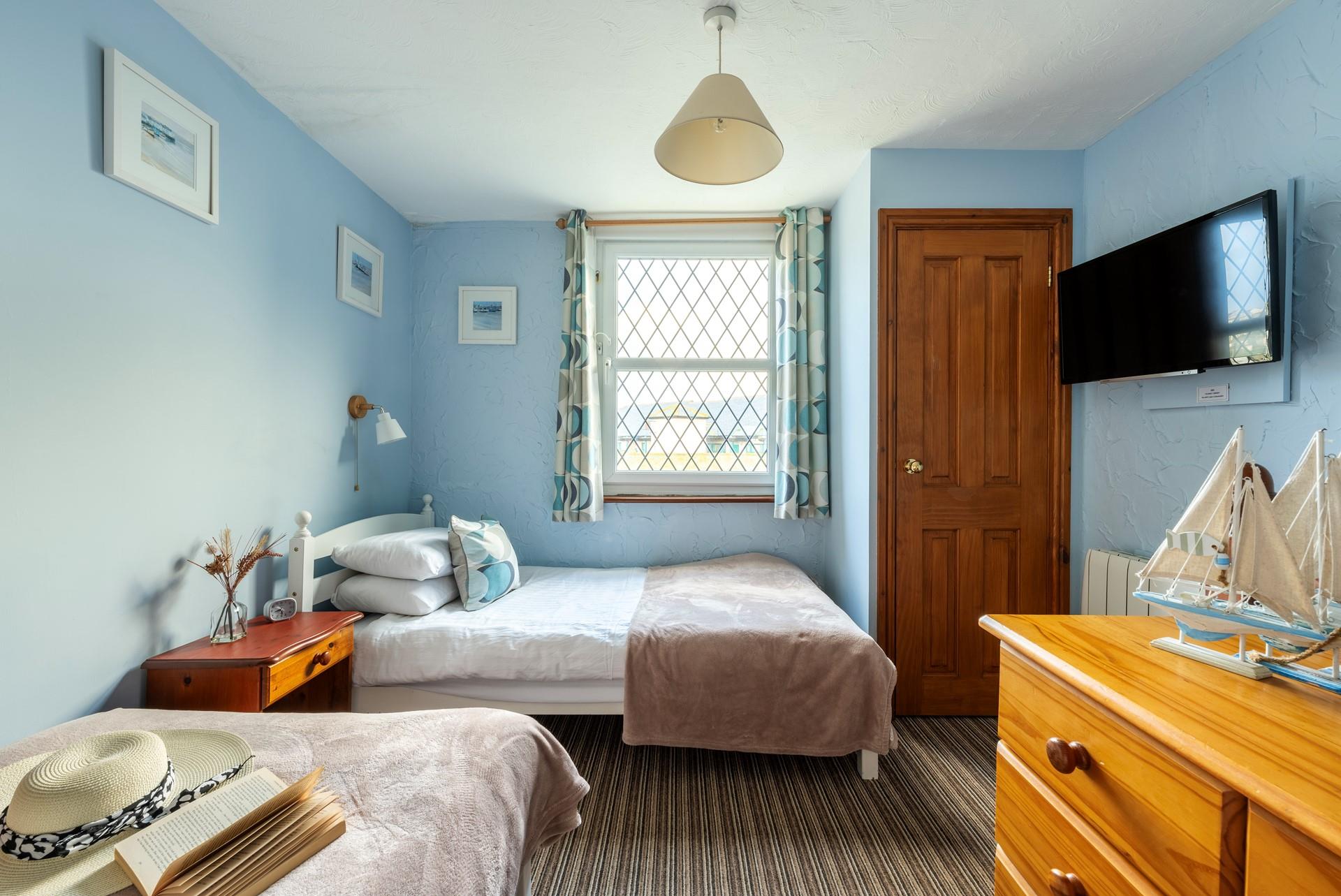 Bedroom 3 has a nautical and blue theme and is a cosy space for 2 people.