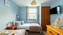 Bedroom 3 has a nautical and blue theme and is a cosy space for 2 people.