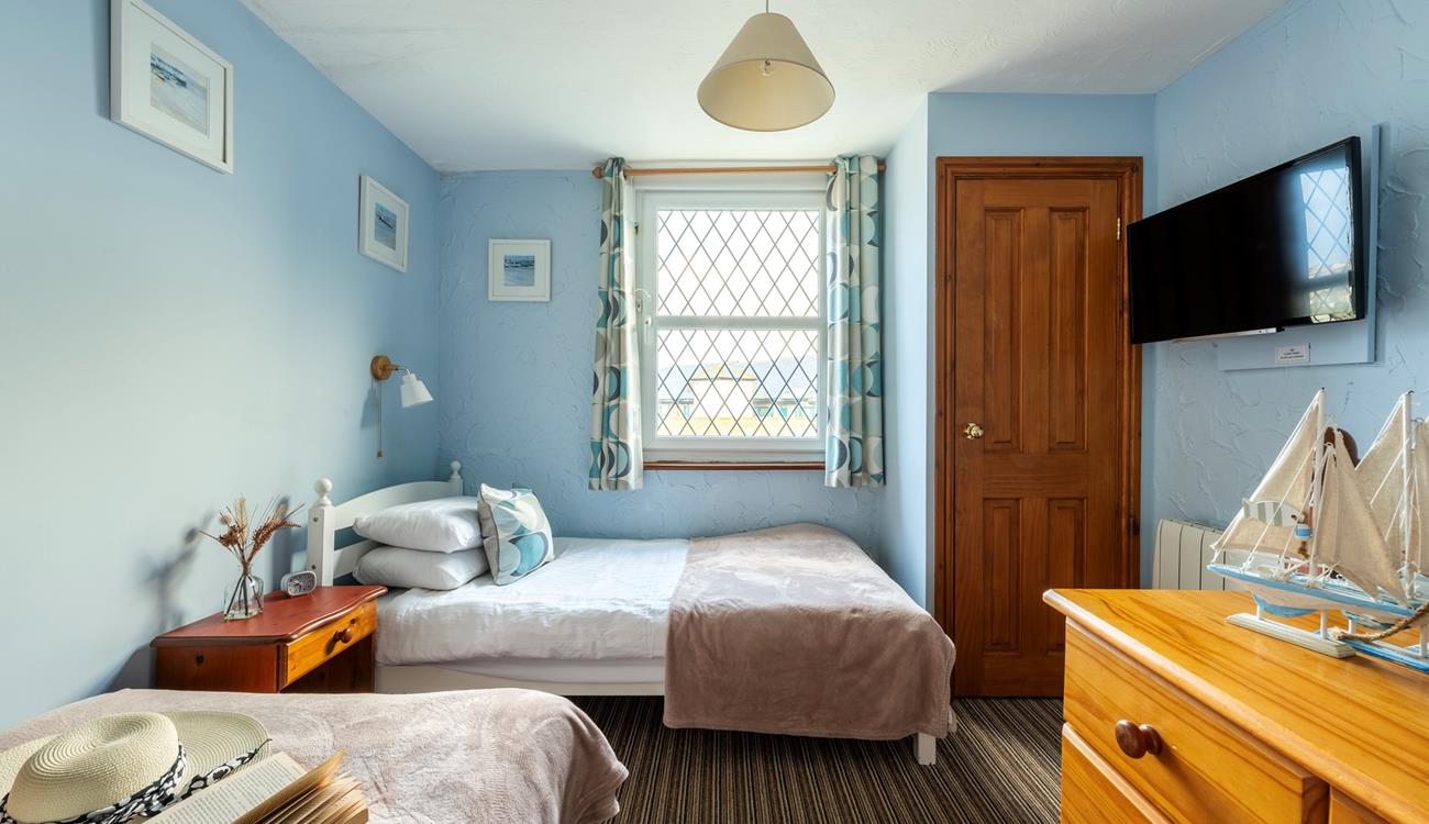 Bedroom 3 has a nautical and blue theme and is a cosy space for 2 people.