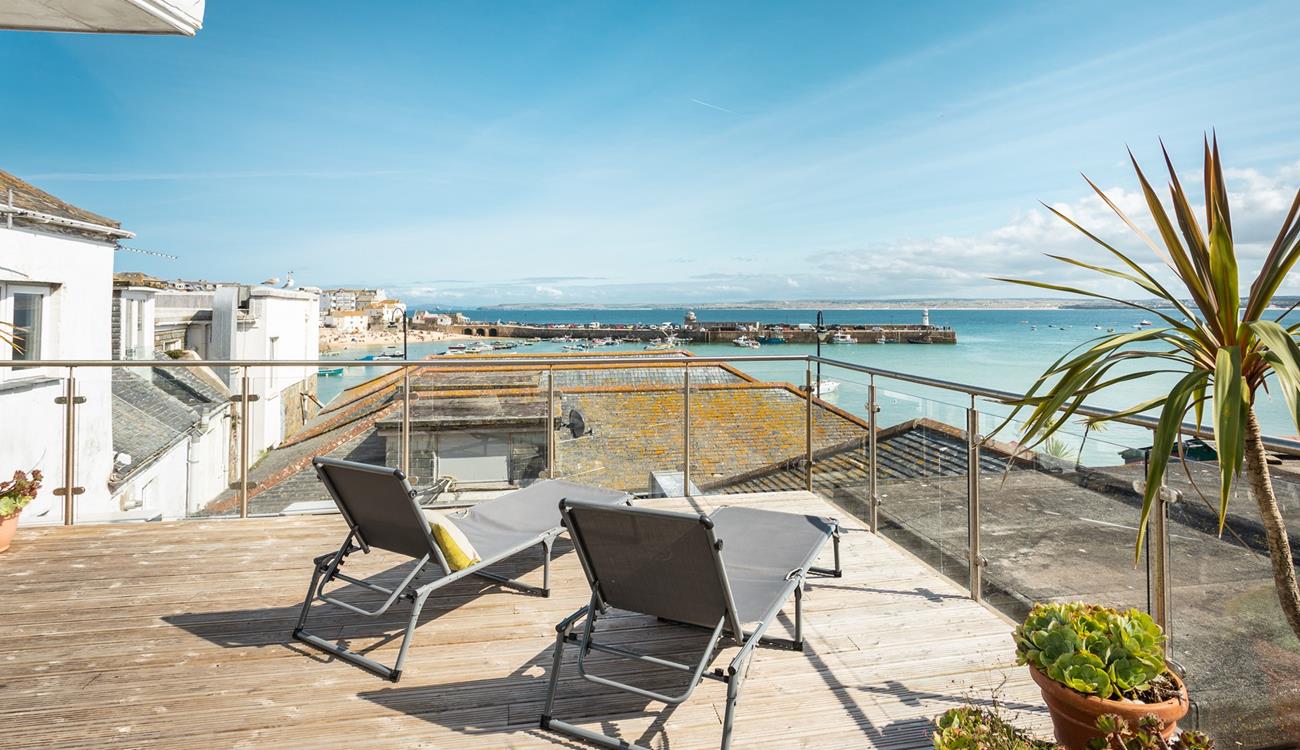 Relax on your rooftop sun lounger with a glass of something cold soaking up the sun in front of stunning views of St Ives.