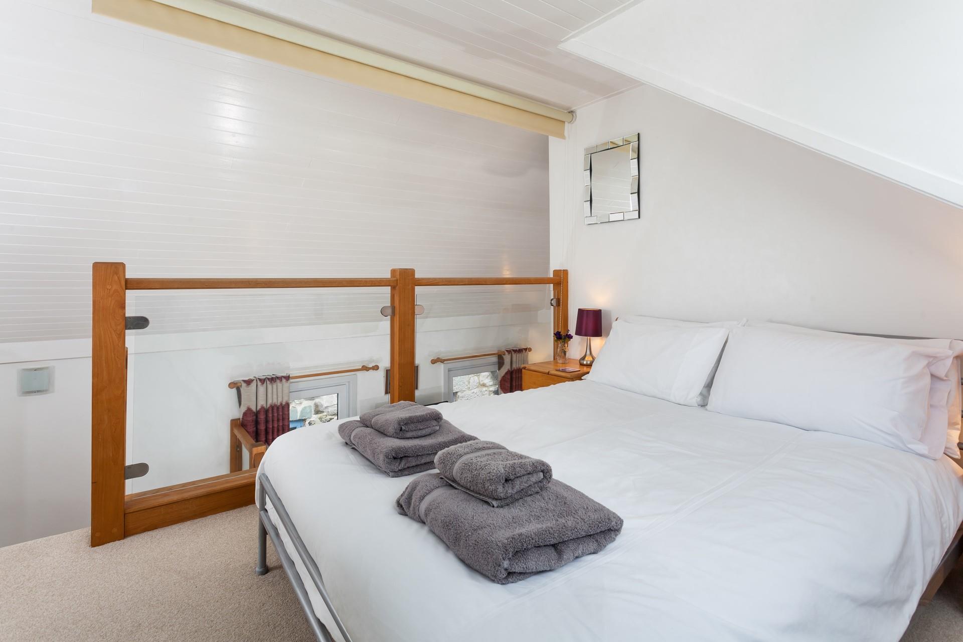 The mezzanine area has a double bed and sea glimpses.