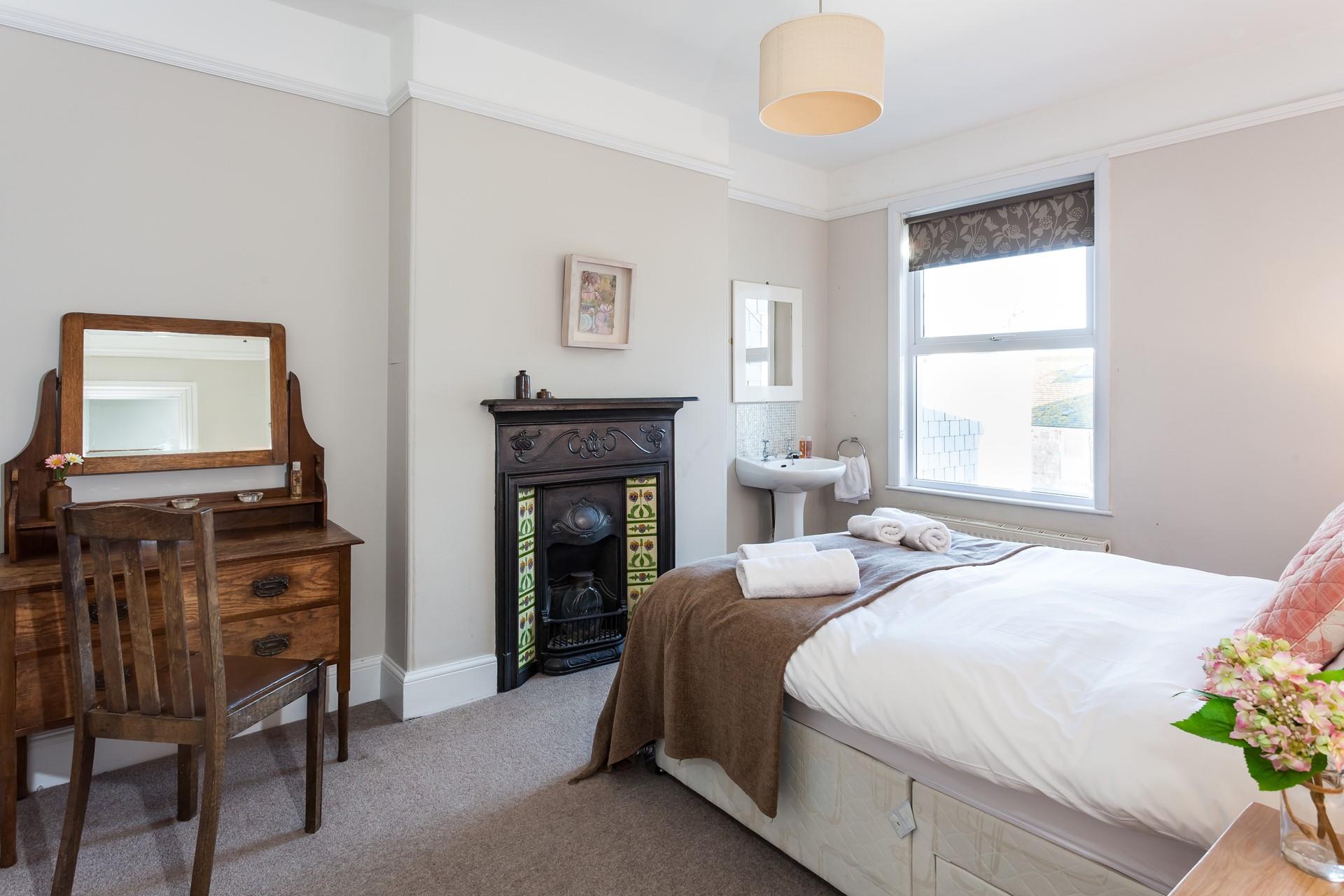 Bedroom 2 has the original cast iron fireplace and provides a cosy base to rest your head.
