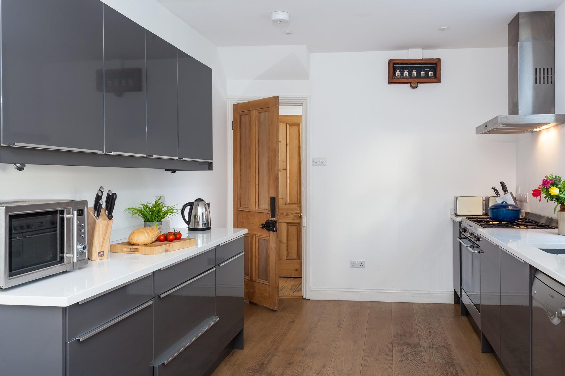 The modern kitchen is fully equipped for cooking tasty feasts for the whole family.