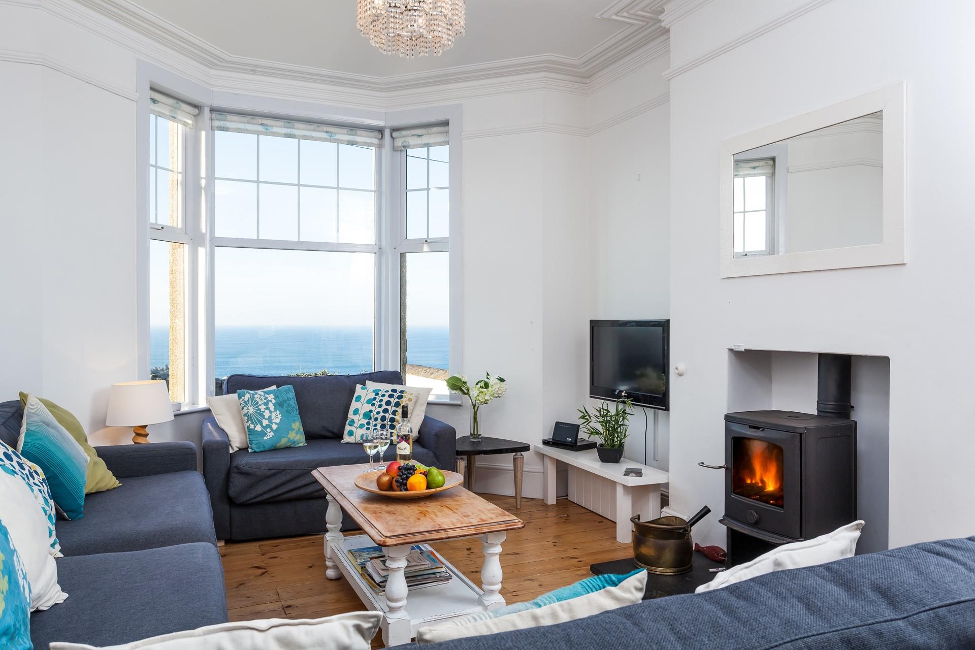Perfectly cosy, the sitting room offers stunning views and a crackling woodburner, what more could you want?