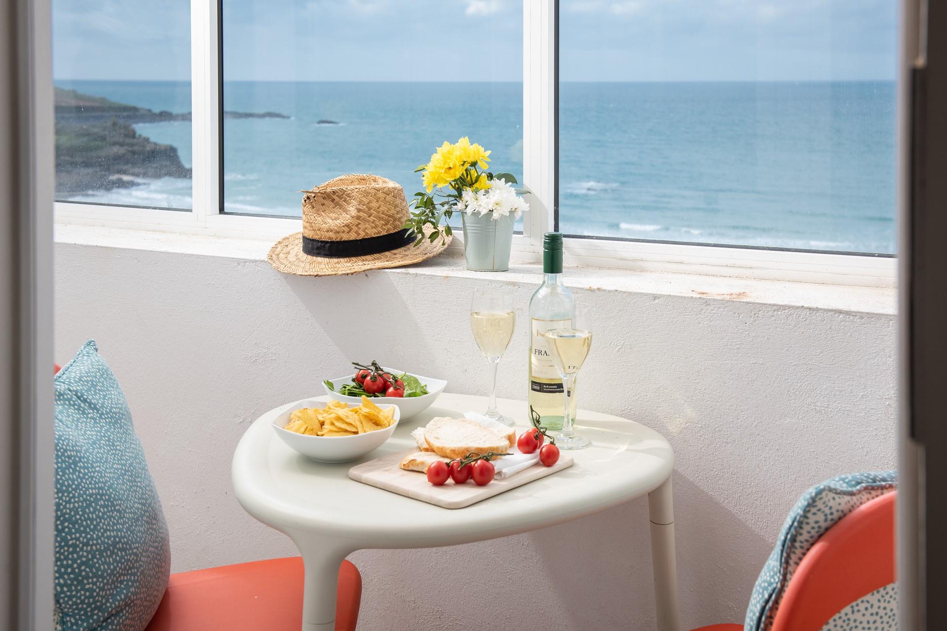 Open a bottle of wine and tuck into delicious nibbles watching the waves roll onto shore.