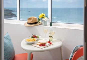 Open a bottle of wine and tuck into delicious nibbles watching the waves roll onto shore.