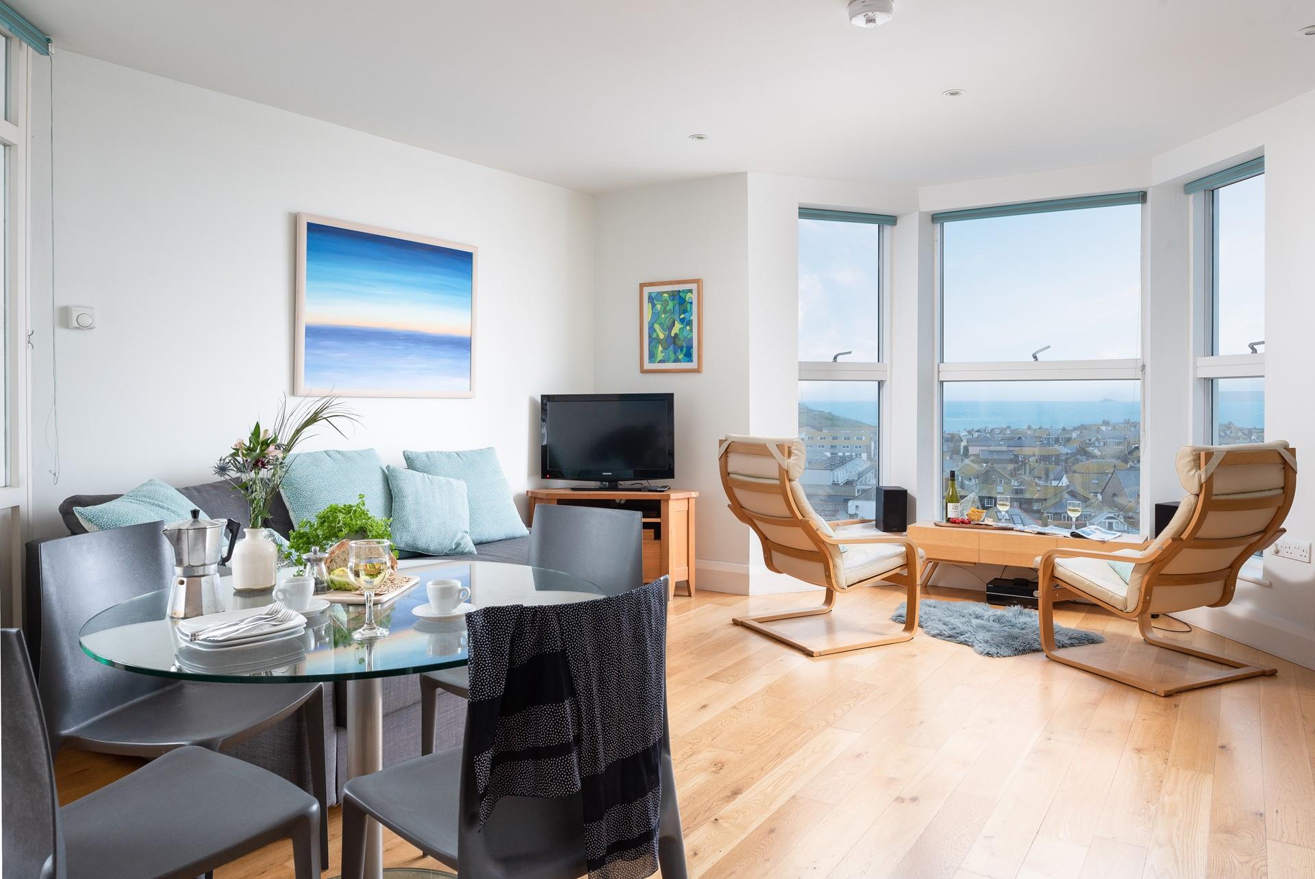 Sit in the window and enjoy the stunning view of the sea over the rooftops.