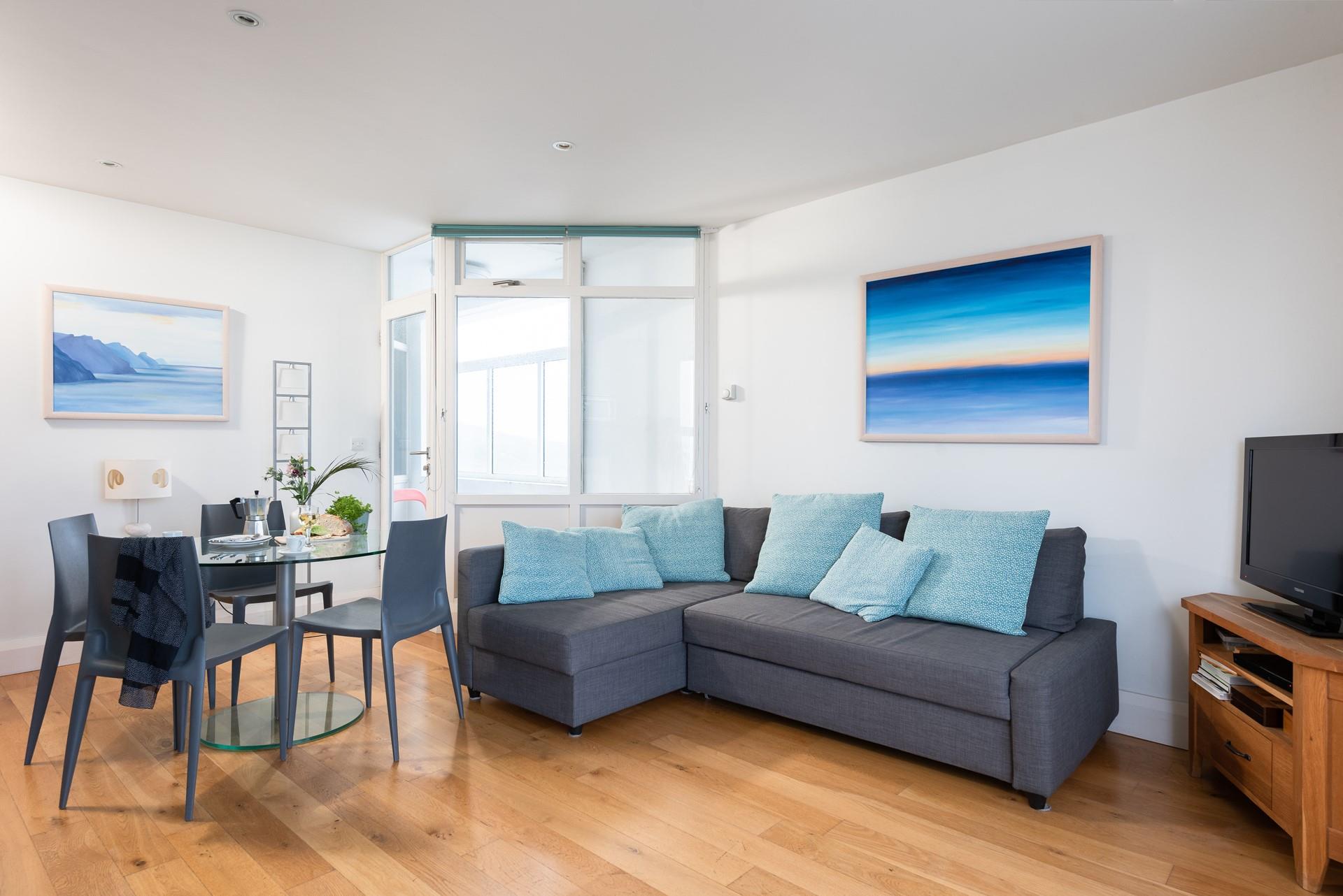 The blue furnishings and artwork reflect the close proximity to the seaside.