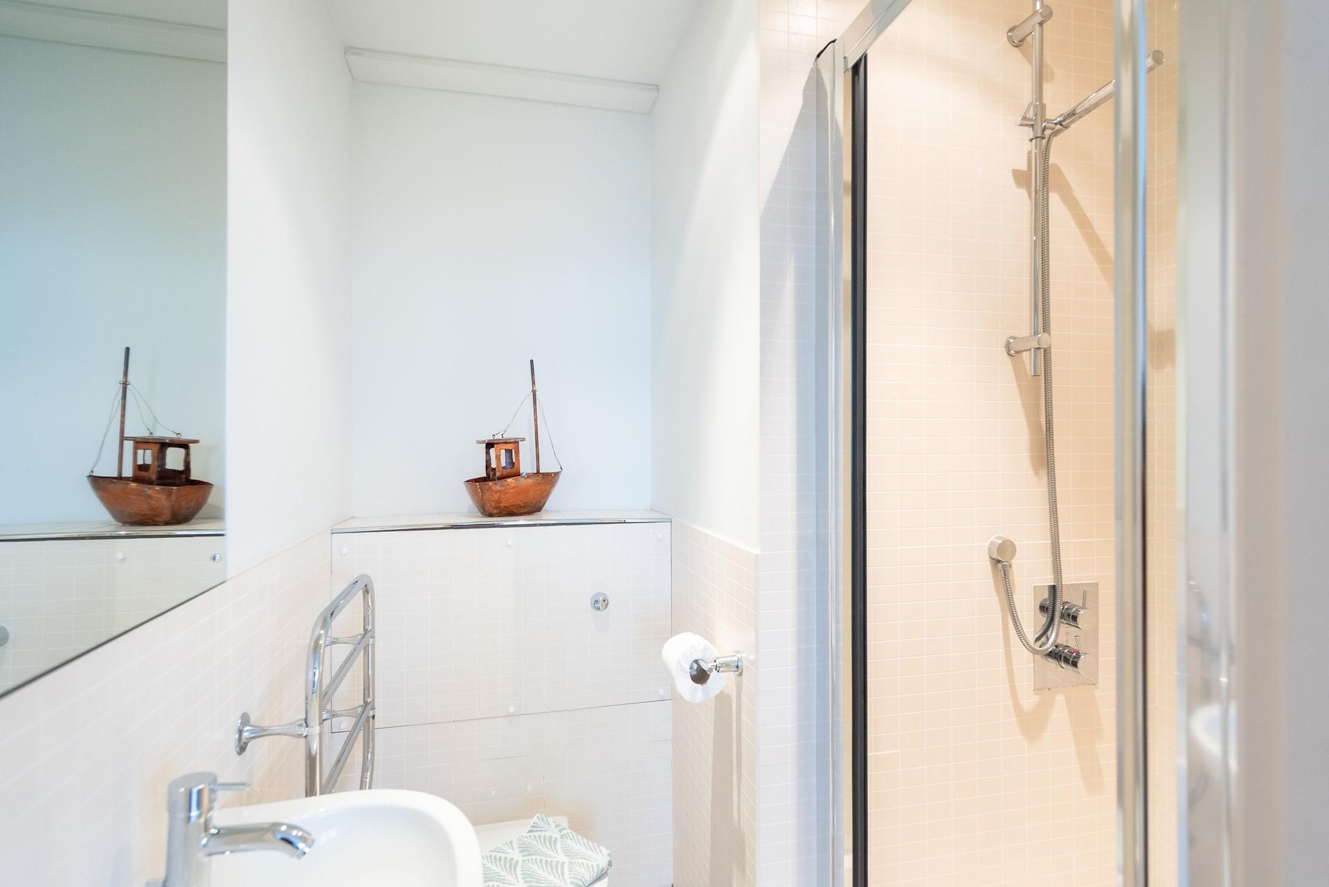 Wash off sandy toes in the en suite shower room.
