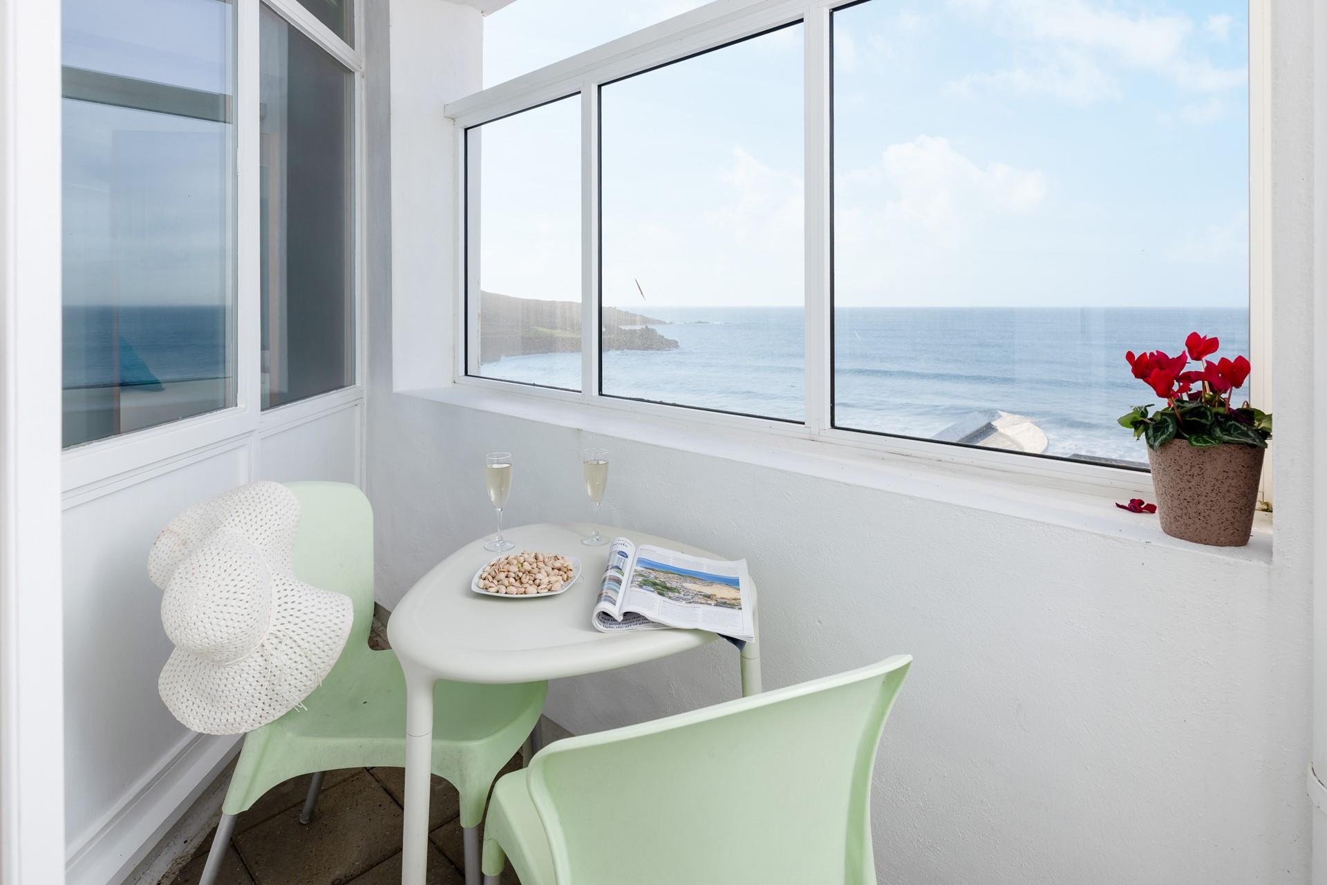 Open a bottle of wine and tuck into delicious nibbles watching the waves roll onto shore.