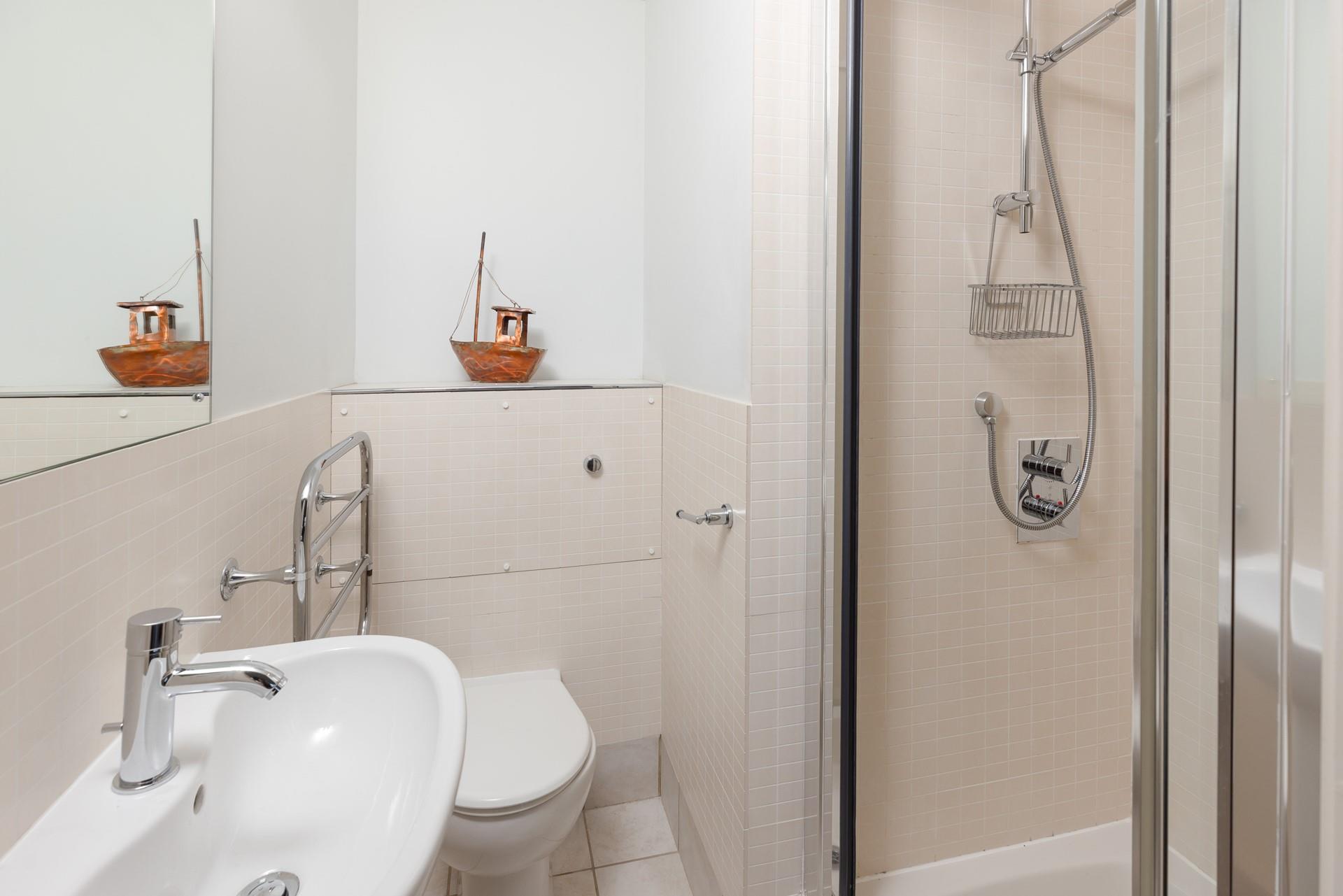 Wash off sandy toes in the en suite shower room.