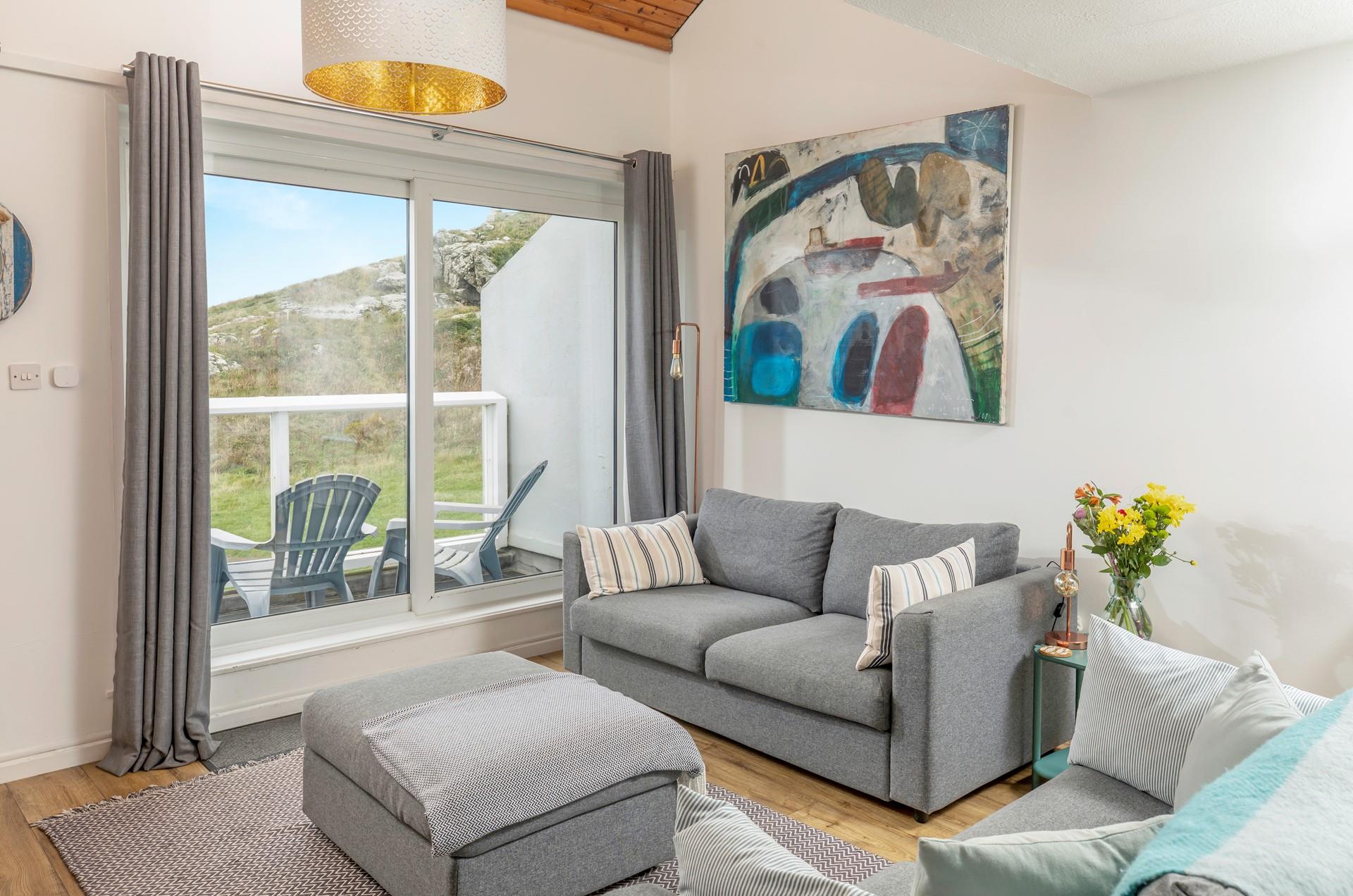 Put your feet up in the cosy living room after a day on the beach.