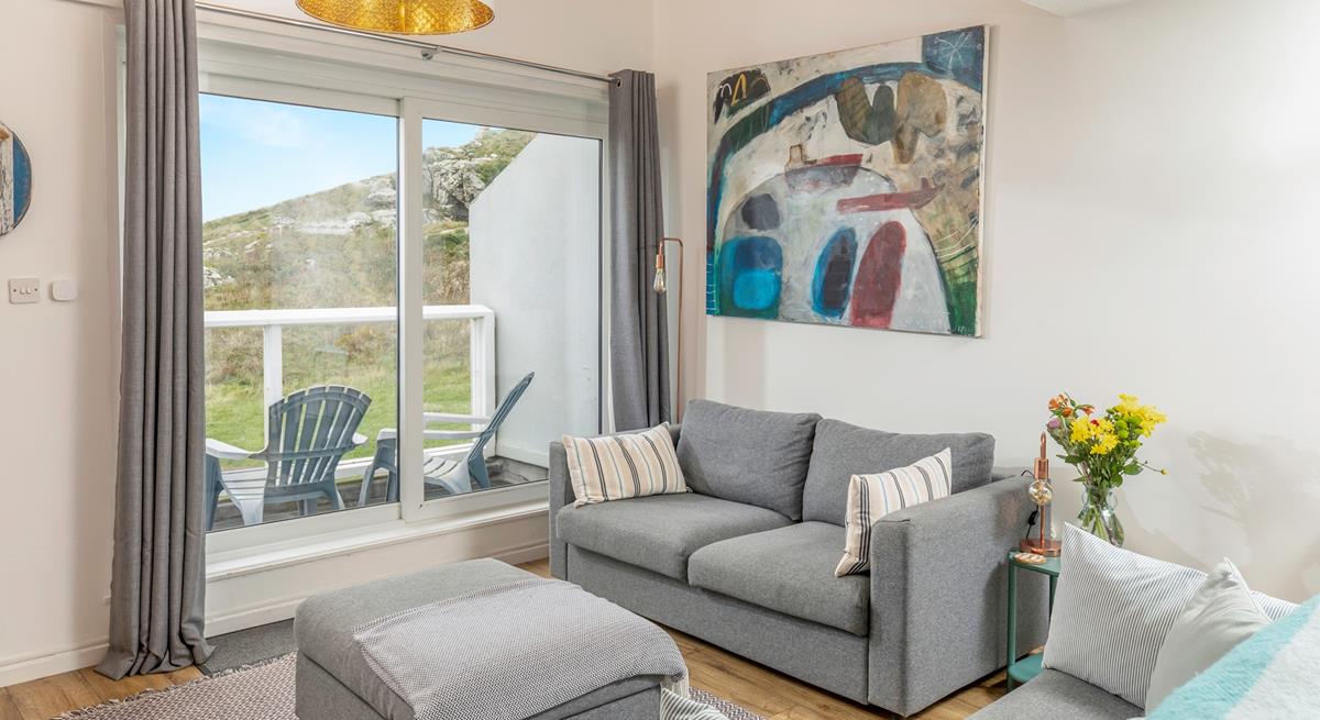 Put your feet up in the cosy living room after a day on the beach.