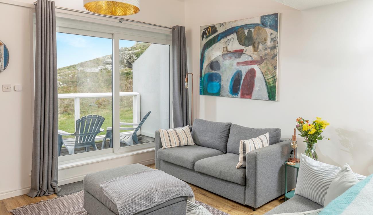 Put your feet up in the cosy living room after a day on the beach.