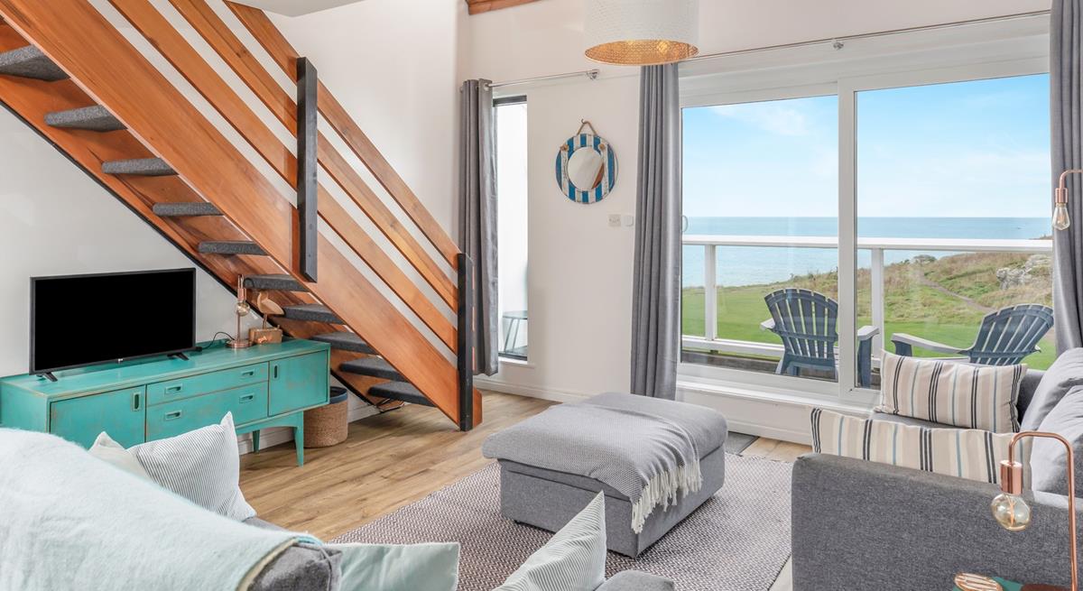 Relax in your sitting area with a glass of wine looking out to sea.