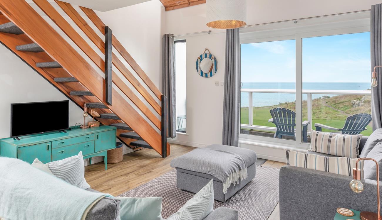 Relax in your sitting area with a glass of wine looking out to sea.