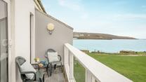 Grab your morning coffee and listen to the waves crash against the rocks on your balcony.
