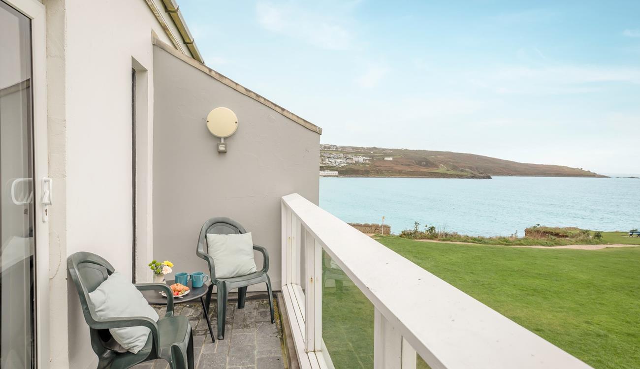 Grab your morning coffee and listen to the waves crash against the rocks on your balcony.
