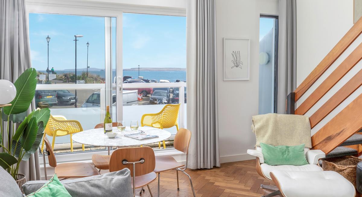 The sitting room is a lovely contemporary space with sea views.