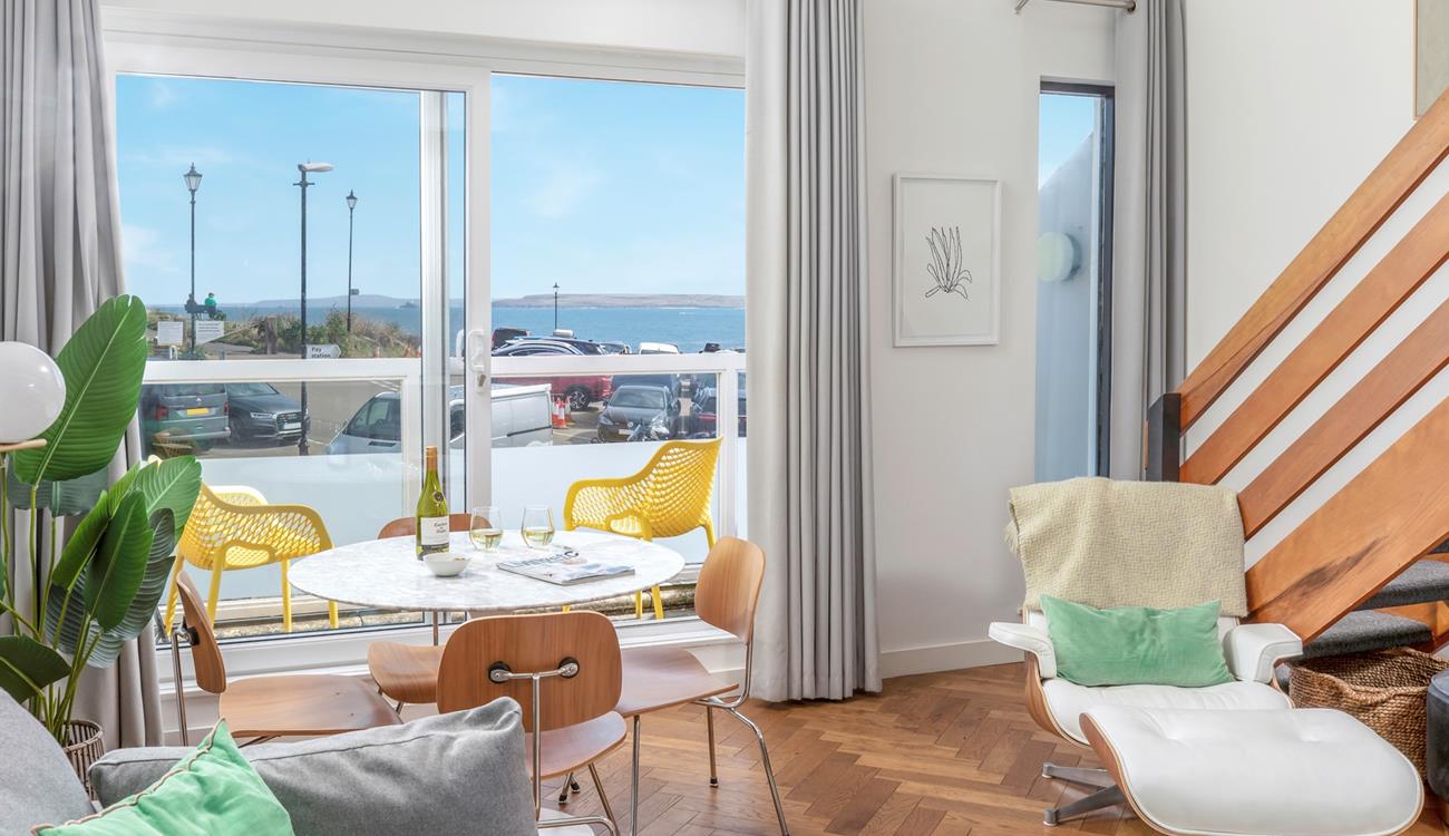 The sitting room is a lovely contemporary space with sea views.
