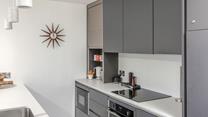The sleek kitchen has all the modern amenities you need.