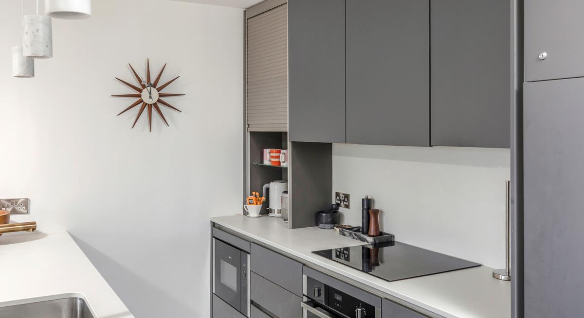 The sleek kitchen has all the modern amenities you need.