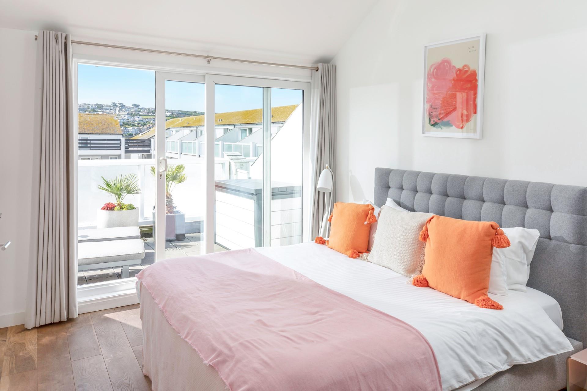 Bedroom 1 has a cosy super king bed and sliding patio doors onto the rear balcony.