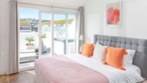 Bedroom 1 has a cosy super king bed and sliding patio doors onto the rear balcony.