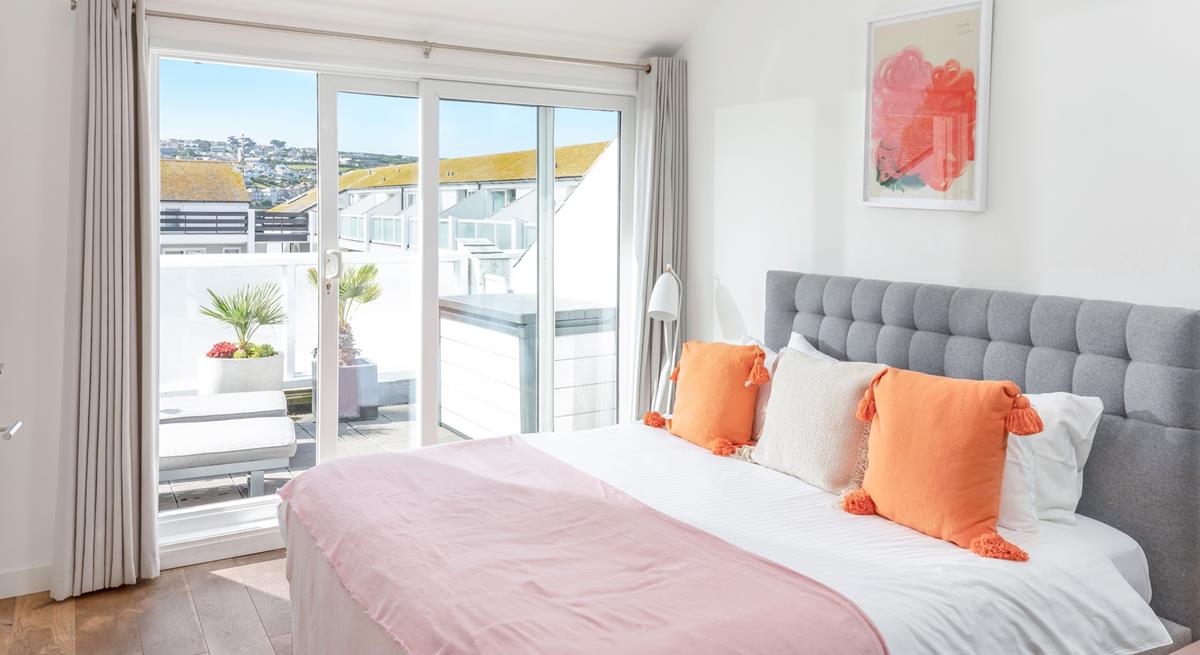 Bedroom 1 has a cosy super king bed and sliding patio doors onto the rear balcony.