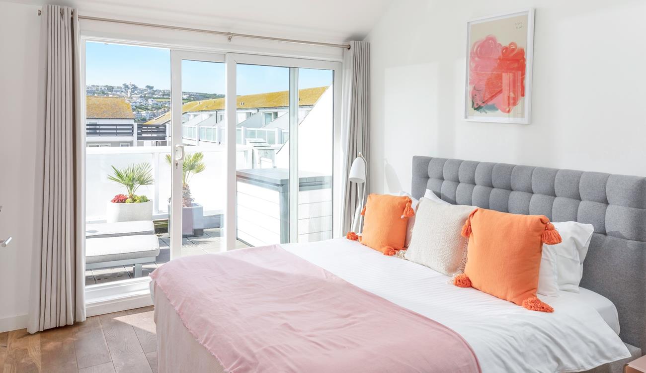 Bedroom 1 has a cosy super king bed and sliding patio doors onto the rear balcony.