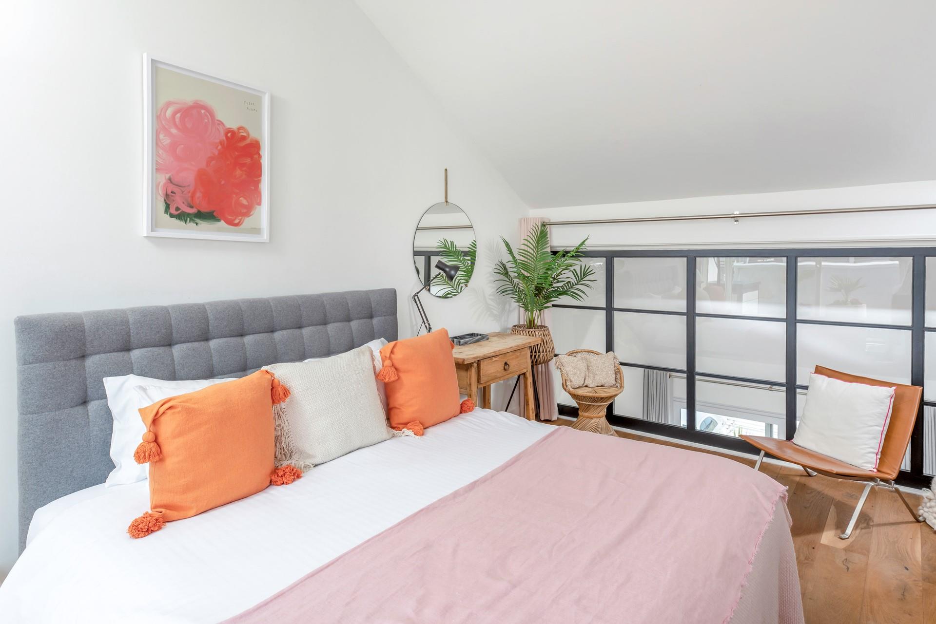 Pops of colour brighten the light and airy bedroom.