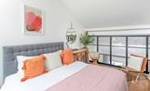 Pops of colour brighten the light and airy bedroom. - Thumbnail Image