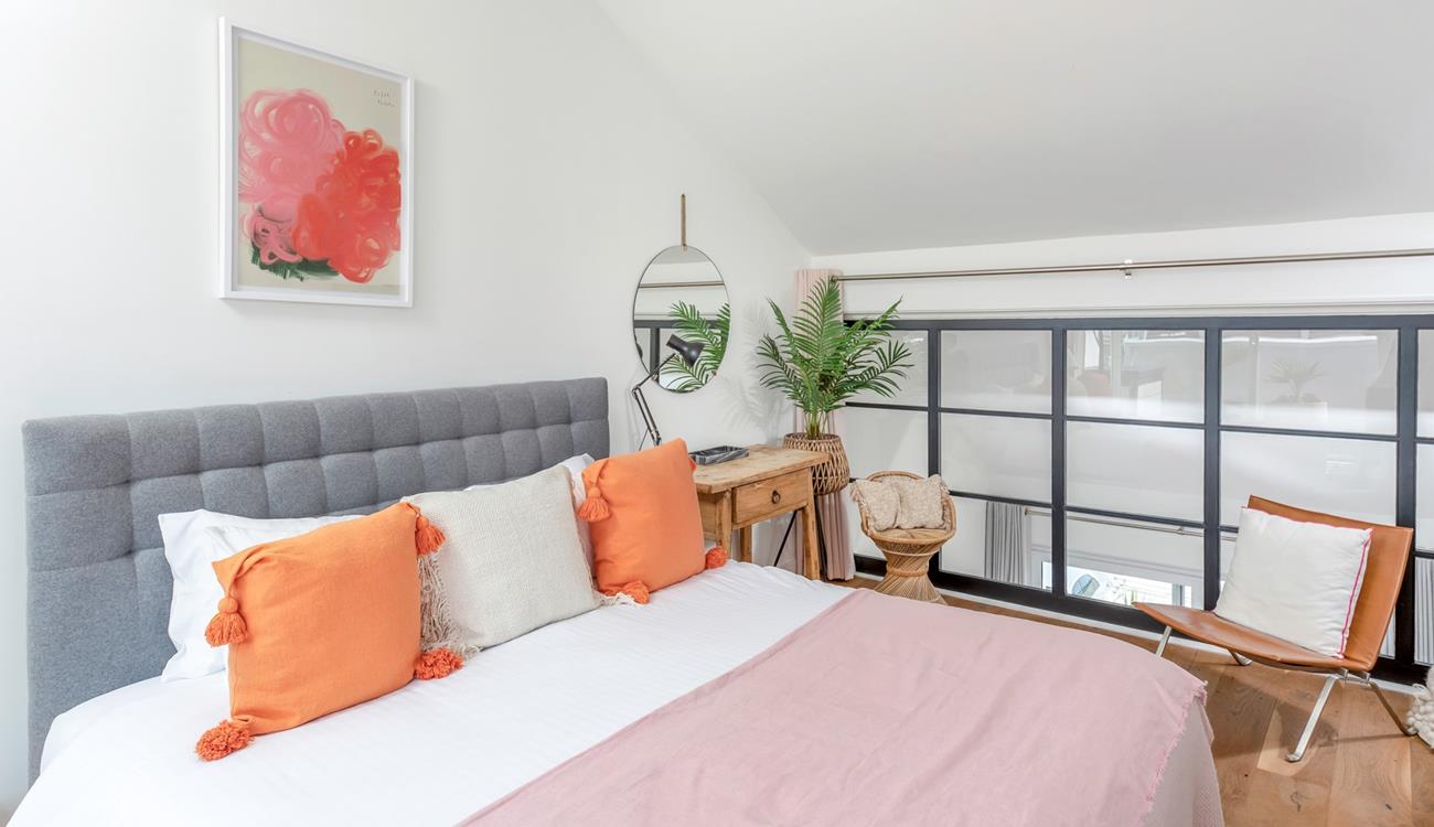 Pops of colour brighten the light and airy bedroom.