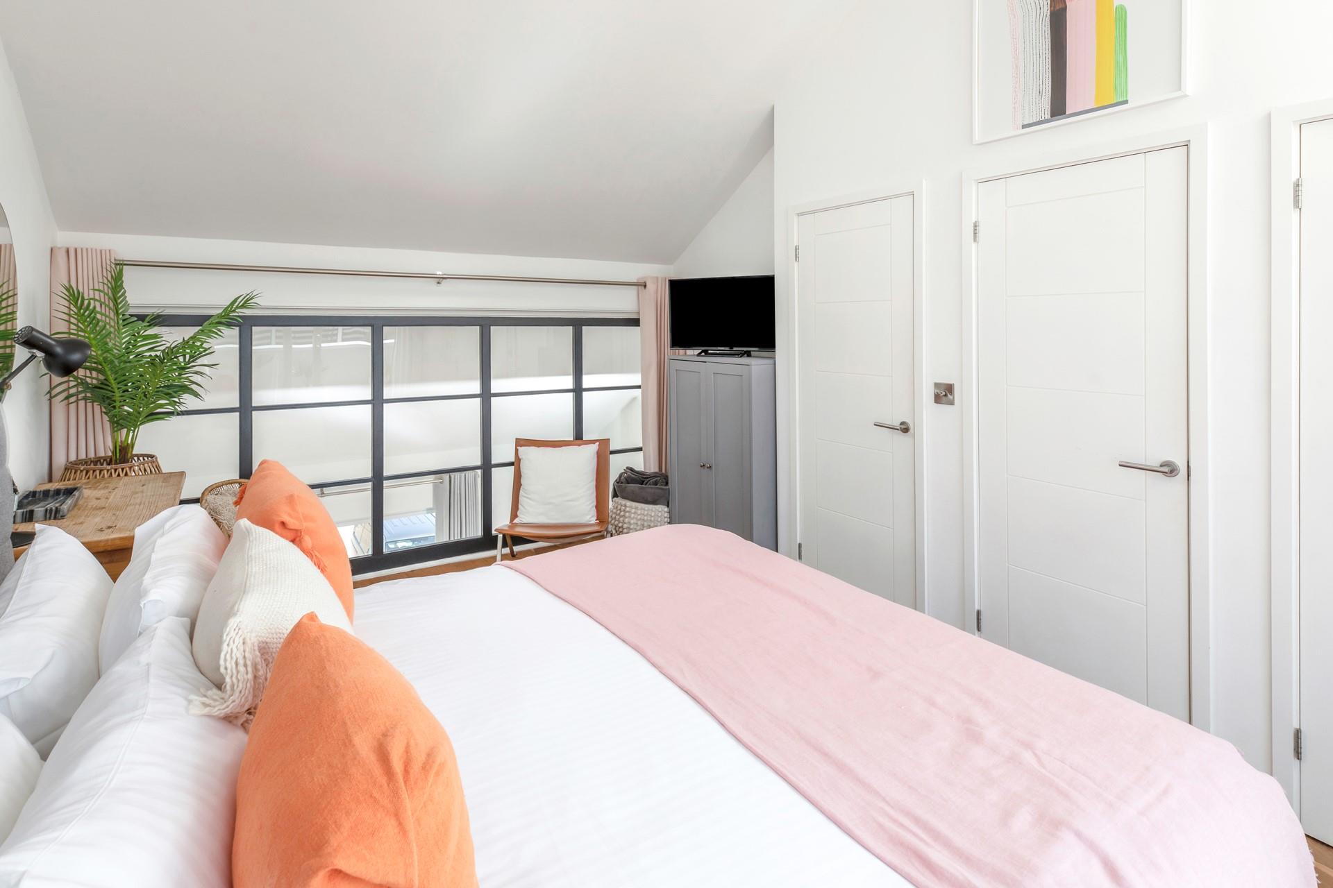 The bedroom has soft sheets and plump pillows for a relaxing night's sleep.